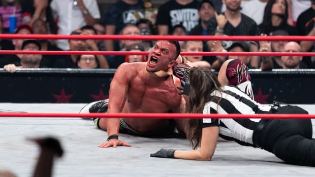 Bryan Danielson chokes Ricky Starks with a leather strap at AEW All Out